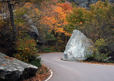 Vermont Fall Leaves and Road Winding Around Boulders
